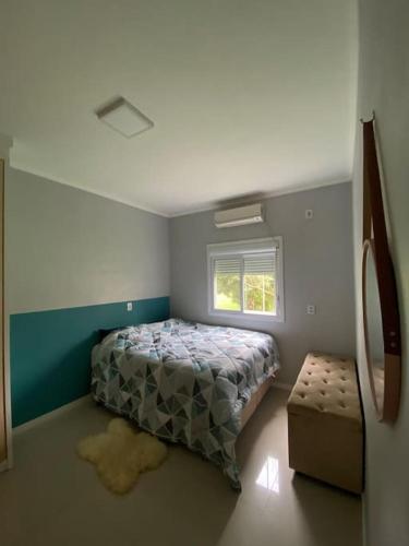 a bedroom with a bed and a window at Casa com banheira e lareira 12km da cidade in Santa Cruz do Sul