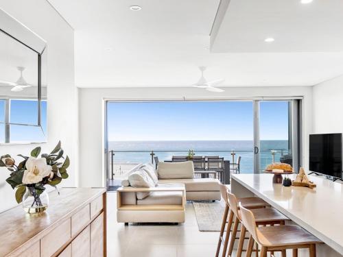 a kitchen and living room with a view of the ocean at White Sails 4 - Amazing views over Convent in Yamba