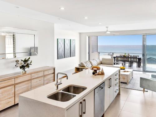 a kitchen with a view of the ocean at White Sails 4 - Amazing views over Convent in Yamba