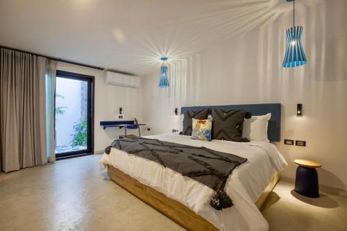 a bedroom with a large bed and blue lights at Quinta Lolita - La Paz Baja California Sur in La Paz