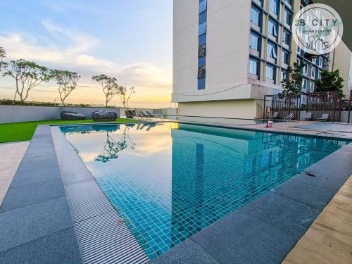 a large swimming pool in front of a building at JB Paradigm Mall by RR JBcity in Johor Bahru