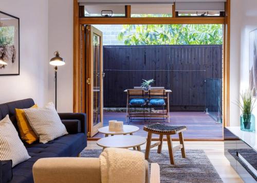 a living room with a couch and a table at 2 Bdrm Apt in Annandale with Courtyard & Parking in Sydney