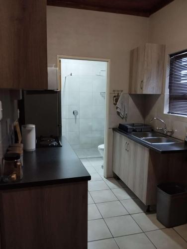 a kitchen with a toilet and a sink and a shower at Hopetown Accommodation in Hopetown