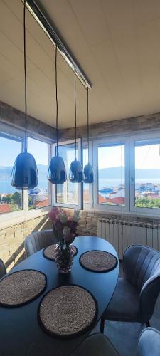 a room with a table and chairs and blue lights at Apartments Ita - Postira in Postira