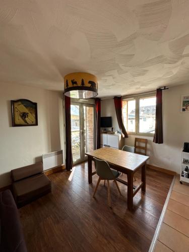 a living room with a table and a couch at STUDIO Perce Neige Lagrange in Saint-Lary-Soulan