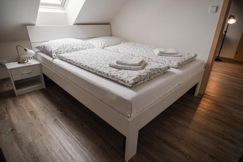 a bedroom with a bed with two towels on it at Farma Tasov in Velké Meziříčí