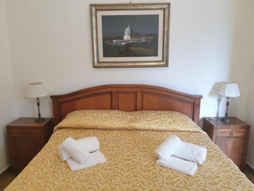 a bedroom with a bed with two pillows on it at Le Rondinelle in San Demetrio neʼ Vestini