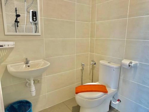 a bathroom with a toilet and a sink at Mutiara Melaka Beach Resort by Glex in Tangga Batu