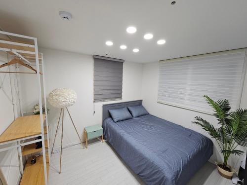 a bedroom with a bed and a ladder in it at Terrace House Hwagok station in Seoul