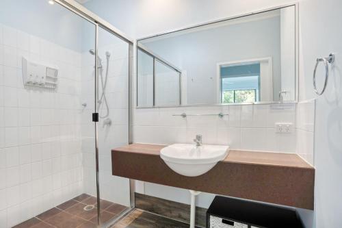 a bathroom with a sink and a shower at Baden 58 - Rainbow Shores. Aircon. Wifi. Pools Walk to beach in Rainbow Beach