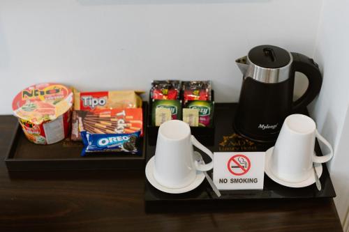 a table with food snacks and a coffee maker on it at Hồng Vận Hotel in Hanoi