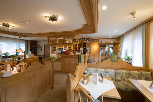 a large kitchen with wooden cabinets and a dining room at Wald-Hotel Heppe in Dammbach