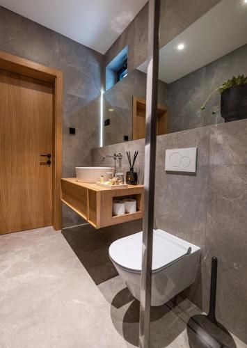 a bathroom with a tub and a sink and a toilet at MareLux in Dubrovnik