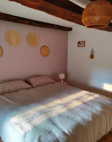 a bedroom with a large bed in a room at Gîte au gré du vent in La Goutelle
