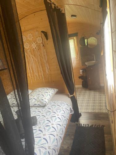 a bed in a small room in a cabin at Roulotte , hébergement atypique in Solliès-Pont