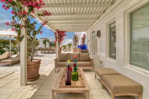 a patio with a table with two bottles of wine at Villa Bellonia in Naousa