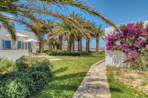 a villa with palm trees and flowers at Villa Bellonia in Naousa