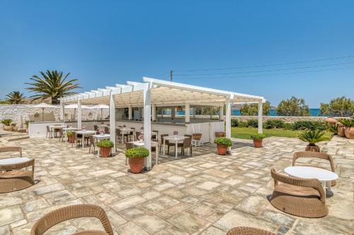 a patio with tables and chairs and a pavilion at Villa Bellonia in Naousa
