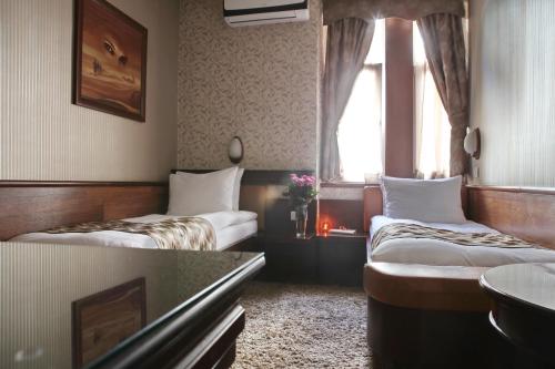 a hotel room with two beds and a window at Vila Terazije in Belgrade