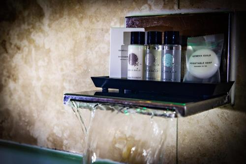a shelf with bottles of cosmetics on a table at Crown Spa Hotel Scarborough by Compass Hospitality in Scarborough