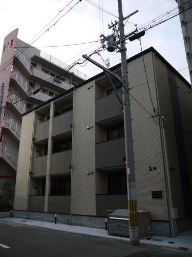 an apartment building on the corner of a street at Ashe Maison Tennoji West II in Osaka