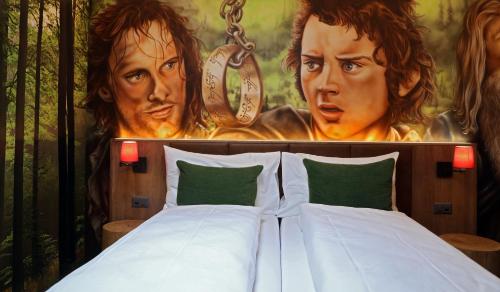 a bedroom with a bed with a painting of two men at Hotel Cinema 8 in Schöftland