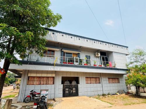 a building with a motorcycle parked in front of it at Shukla Guest House in Durg