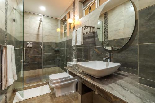 a bathroom with a sink and a mirror at Dallas Premiere Hotel in Kisii