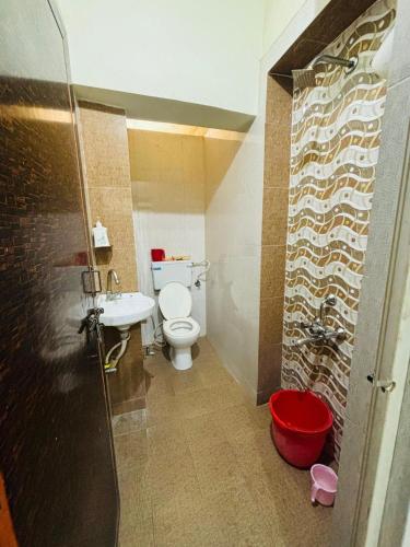 a bathroom with a toilet and a sink at Shukla Guest House in Durg