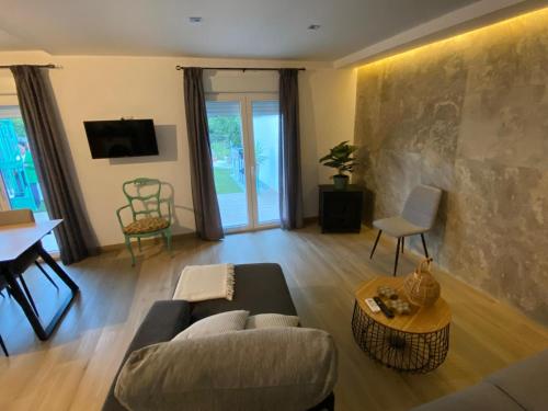 a living room with a couch and a table at Casa rural La Vereda del rio Guadalquivir in Mogón