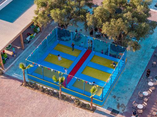 an overhead view of a large swimming pool with people in it at Caretta Paradise Resort & WaterPark in Tragaki