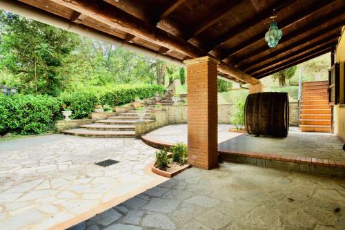 an outdoor patio with a brick pergola and stairs at Beautiful country house in the heart of Tuscany in Capolona