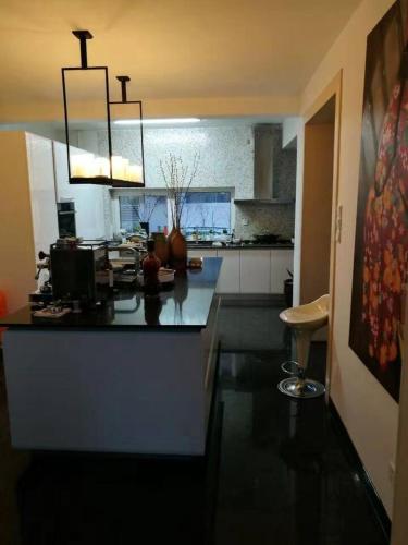 a kitchen with a black counter top in a room at Yanjiao Villa in Beijing