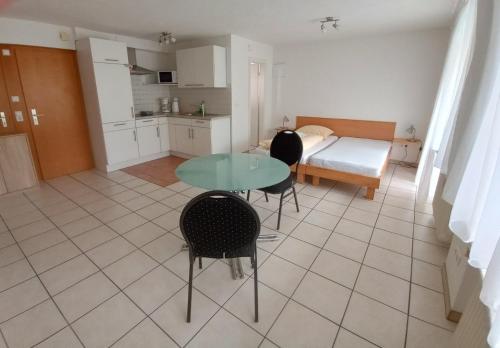 a room with a table and chairs and a bedroom at Hotel Victoria in Weil am Rhein