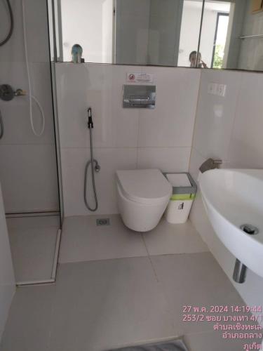 a bathroom with a shower and a toilet and a sink at Tao Resort and Villas (SHA Extra+) in Phuket