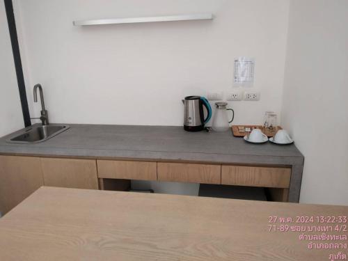 a kitchen with a counter top with a sink and a counter top at Tao Resort and Villas (SHA Extra+) in Phuket