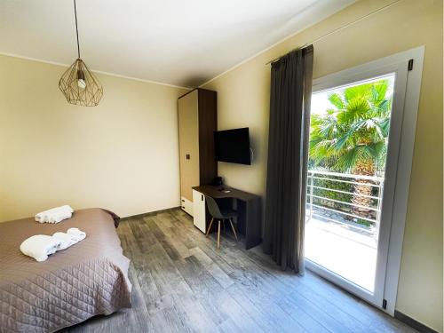 a bedroom with a bed and a sliding glass door at Terra D'Aspra in Bagheria