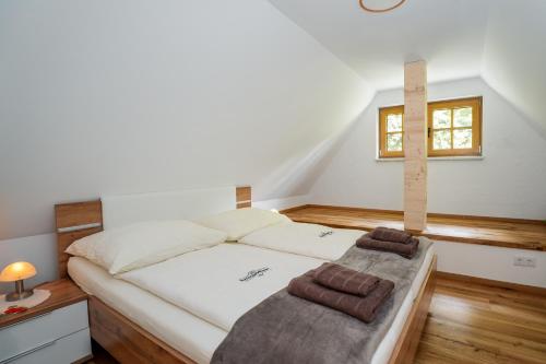 a bedroom with a white bed with a window at NaturparkResort s`Keuscherl in Wildalpen