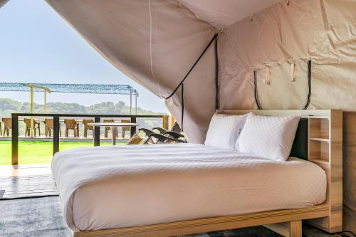 a bedroom with a canopy bed and a balcony at Top of Mountain Miaoli in Taian