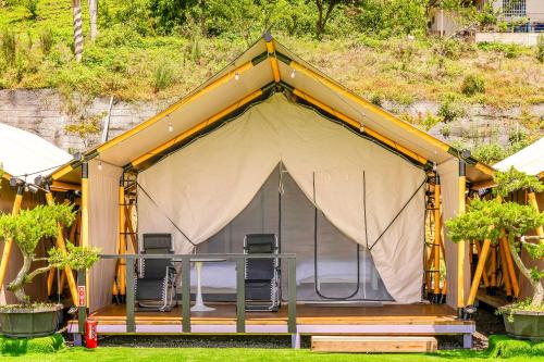 a tent with a table and chairs in it at Top of Mountain Miaoli in Taian