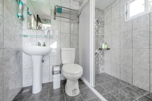 a white bathroom with a toilet and a sink at Top of Mountain Miaoli in Taian