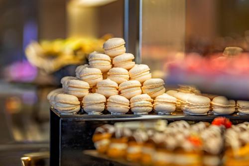 a pile of donuts on display in a bakery at KRESTEN ROYAL Euphoria Resort in Kallithea Rhodes