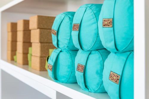 a stack of blue dominoes on a shelf with boxes at KRESTEN ROYAL Euphoria Resort in Kallithea Rhodes