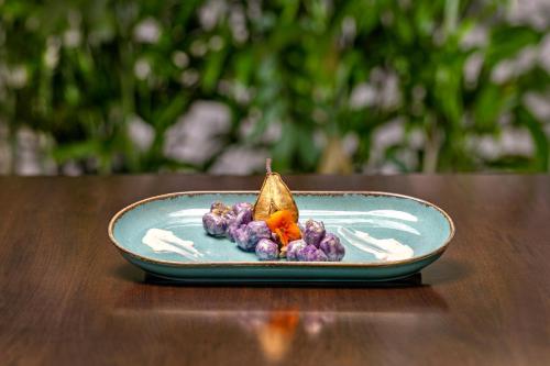 a plate of food on a wooden table at KRESTEN ROYAL Euphoria Resort in Kallithea Rhodes
