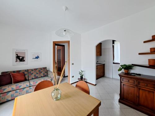 a living room with a table and a couch at Casa Sofi by Quokka 360 - near Rezzonico Castle in Rezzonico