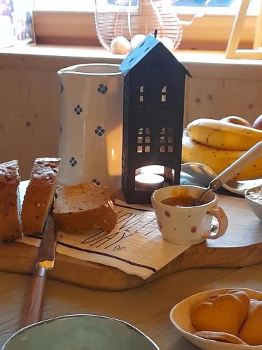 a table topped with bread and a cup of coffee at B&B Chalet Dolomiti in Sant’Orsola