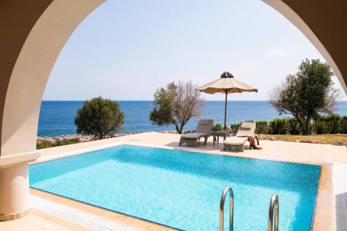 a swimming pool with a view of the ocean at KRESTEN ROYAL Euphoria Resort in Kallithea Rhodes