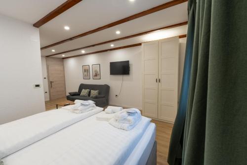 a bedroom with a bed with towels on it at Hotel Maslina in Seget