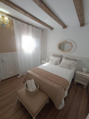 a bedroom with a large bed and a mirror at Casa Laura y Pancho in Fasnia