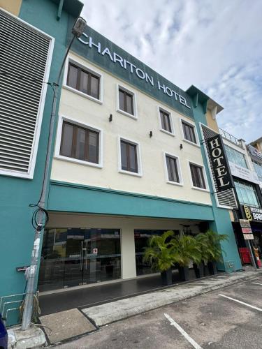 a building with a sign for the hotel at Chariton Hotel Nusa Bestari in Johor Bahru